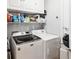 Well-equipped laundry room features a Maytag washer and dryer and ample storage space with white cabinets at 14457 Jamaica Dogwood Dr, Orlando, FL 32828