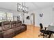 Bright living room boasts hardwood floors, modern lighting, and neutral paint at 14457 Jamaica Dogwood Dr, Orlando, FL 32828