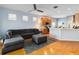 Open-concept living area with hardwood floors, sectional sofa, and seamless flow into the kitchen at 14457 Jamaica Dogwood Dr, Orlando, FL 32828