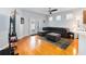 Bright living room showcasing hardwood floors, comfortable seating, and sliding glass doors to the exterior at 14457 Jamaica Dogwood Dr, Orlando, FL 32828
