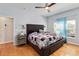 Spacious main bedroom with a large bed, ceiling fan, and natural light from the window at 14457 Jamaica Dogwood Dr, Orlando, FL 32828