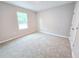 Bright bedroom with neutral walls and carpet at 160 Guava Ter, Ocklawaha, FL 32179