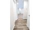 Clean and bright hallway with wood-look floors at 160 Guava Ter, Ocklawaha, FL 32179