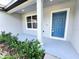 Newly constructed home with gray siding, blue door, and manicured landscaping at 160 Guava Ter, Ocklawaha, FL 32179