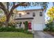 Two-story house with a front porch, attached garage, and landscaped yard at 1801 Woodward St, Orlando, FL 32803