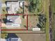 Aerial view of two parcels of land, one with a house and the other vacant at 193 Aurelia Ct, Kissimmee, FL 34758