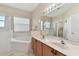 Bathroom with a double vanity, soaking tub, and shower at 193 Aurelia Ct, Kissimmee, FL 34758