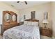 Bedroom with a floral comforter and wooden furniture at 193 Aurelia Ct, Kissimmee, FL 34758
