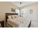 Main bedroom with a king-size bed and sitting area at 193 Aurelia Ct, Kissimmee, FL 34758