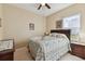 Bedroom with floral bedding, nightstand, and ceiling fan at 193 Aurelia Ct, Kissimmee, FL 34758