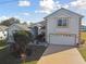 Two story home featuring an attached two car garage and well-maintained landscaping at 193 Aurelia Ct, Kissimmee, FL 34758