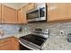 Kitchen detail showing stainless steel stove and microwave at 193 Aurelia Ct, Kissimmee, FL 34758