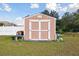 Tan shed with double doors in backyard at 193 Aurelia Ct, Kissimmee, FL 34758