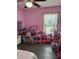 bedroom with pink walls, a bed, and various toys and furniture at 2059 Dixie Belle Dr # 2059P, Orlando, FL 32812