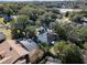 Aerial view of a home with a pool and screened enclosure in a wooded neighborhood at 2061 Petit Ct, Apopka, FL 32712