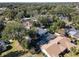 Aerial view of a home with a pool and screened enclosure, surrounded by mature trees at 2061 Petit Ct, Apopka, FL 32712