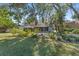 Spacious backyard with mature trees and lush green grass at 2061 Petit Ct, Apopka, FL 32712