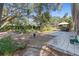 Landscaped backyard with hot tub, patio, and mature trees at 2061 Petit Ct, Apopka, FL 32712