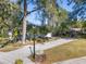 Landscaped yard with mature trees and a walkway to the house at 2061 Petit Ct, Apopka, FL 32712