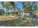 Landscaped front yard with a pergola and mature trees at 2061 Petit Ct, Apopka, FL 32712
