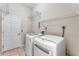 Laundry room with washer, dryer, and ample shelving at 2061 Petit Ct, Apopka, FL 32712