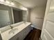 Bathroom featuring double sinks and wood look flooring at 238 Locust Rd, Ocala, FL 34472