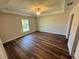 A bedroom showcases a tray ceiling, ceiling fan, and wood-look flooring at 238 Locust Rd, Ocala, FL 34472