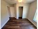 Bedroom with wood flooring, closet, and large window at 238 Locust Rd, Ocala, FL 34472