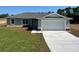 Beautiful house with an attached garage and a well-manicured lawn at 238 Locust Rd, Ocala, FL 34472