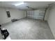 A spacious two car garage with a rolling metal door and concrete floors at 238 Locust Rd, Ocala, FL 34472