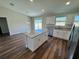 Modern kitchen with an island, granite countertops, stainless steel appliances, and white cabinetry at 238 Locust Rd, Ocala, FL 34472