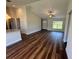 Bright living room featuring hardwood floors, vaulted ceilings, and a window with a view to the lush yard at 238 Locust Rd, Ocala, FL 34472