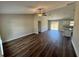 Spacious living room with modern wood-look flooring and a ceiling fan at 238 Locust Rd, Ocala, FL 34472