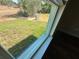 Backyard view from window showcases a lush green yard extending to the property line at 238 Locust Rd, Ocala, FL 34472
