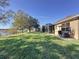 Spacious backyard with a large lawn, screened patio, and lake view at 250 Bayou Bend Rd, Groveland, FL 34736