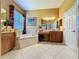 Elegant bathroom with corner bathtub and double vanity at 250 Bayou Bend Rd, Groveland, FL 34736