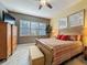 Main bedroom with wood flooring and a large window at 250 Bayou Bend Rd, Groveland, FL 34736
