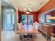 Bright dining room with hardwood floors and an accent wall at 250 Bayou Bend Rd, Groveland, FL 34736