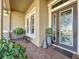 Inviting front porch with brick flooring, potted plants, and a double door entry at 250 Bayou Bend Rd, Groveland, FL 34736