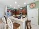 Updated kitchen with wood cabinets, stainless steel appliances, and breakfast bar at 250 Bayou Bend Rd, Groveland, FL 34736