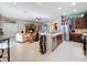 Open concept kitchen with island and living room view at 250 Bayou Bend Rd, Groveland, FL 34736