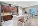 Modern kitchen with dark wood cabinets, stainless steel appliances, and an island at 250 Bayou Bend Rd, Groveland, FL 34736