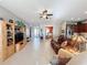 Spacious living room featuring tile floors, a brown couch and built-in shelving at 250 Bayou Bend Rd, Groveland, FL 34736