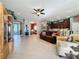Spacious living room with tile floors, a brown couch and built-in shelving at 250 Bayou Bend Rd, Groveland, FL 34736