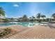 Resort-style pool with spacious deck and palm trees at 250 Bayou Bend Rd, Groveland, FL 34736