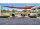 Tennis court with shaded seating area, perfect for relaxation at 250 Bayou Bend Rd, Groveland, FL 34736