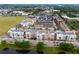 Aerial view showcasing a charming community with shops and apartments near a lake at 2511 Formax Dr, Orlando, FL 32828