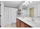 Double vanity bathroom with shower and shelves at 2511 Formax Dr, Orlando, FL 32828