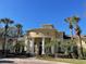 Community clubhouse with columns and landscaping at 2558 Robert Trent Jones Dr # 1427, Orlando, FL 32835