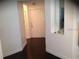 Dark hardwood floors in an entryway with white walls and a door at 2558 Robert Trent Jones Dr # 1427, Orlando, FL 32835